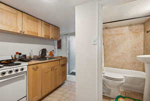 Kitchen featuring white range oven and sink