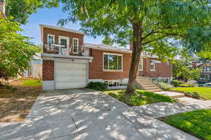 View of front of home featuring a balcony and a garage