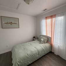 Bedroom featuring a textured ceiling and dark wood-type flooring