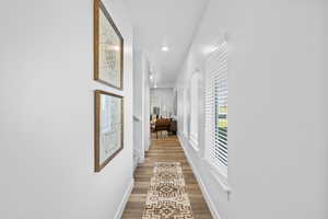 Corridor with hardwood / wood-style flooring *Photo is of an existing home of the same layout. Colors for listed home could vary*