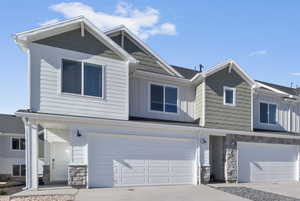 View of front of house with a garage *Photo is of an existing home of the same layout. Colors for listed home could vary*