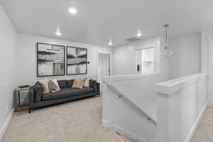 Living room with light colored carpet *Photo is of an existing home of the same layout. Colors for listed home could vary*