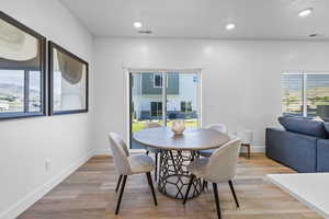 Dining room featuring light wood-type flooring *Photo is of an existing home of the same layout. Colors for listed home could vary*