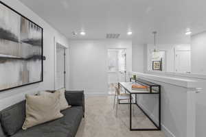 View of carpeted living room *Photo is of an existing home of the same layout. Colors for listed home could vary*