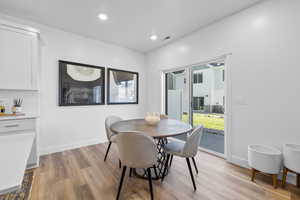 Dining room with light hardwood / wood-style flooring *Photo is of an existing home of the same layout. Colors for listed home could vary*