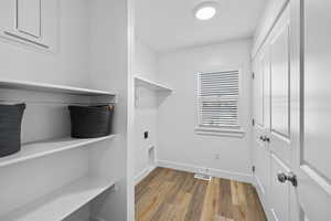 Spacious closet with light hardwood / wood-style floors *Photo is of an existing home of the same layout. Colors for listed home could vary*