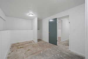 Empty room with a textured ceiling