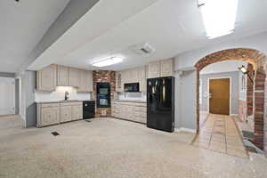 Kitchen with black appliances, a textured ceiling, and sink