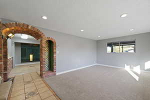 Spare room featuring a textured ceiling and light tile patterned floors