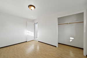 Unfurnished bedroom with light wood-type flooring and a closet