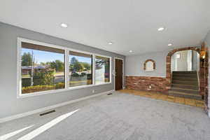 Unfurnished living room with plenty of natural light and carpet flooring