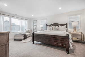 Bedroom featuring light colored carpet