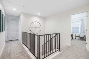 Hallway with light colored carpet