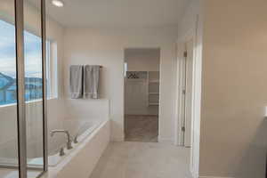 Primary Bathroom with Separate Tub & Shower, and a Large Walk-in Closet