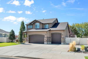 View of front of home featuring cooling unit and a garage