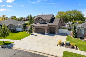 View of front of house featuring a garage and a front lawn