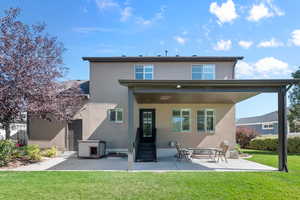 Back of house featuring a patio and a yard