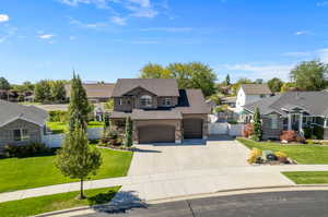 View of front of house with a front lawn and a garage