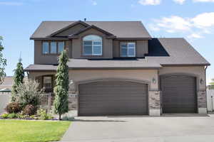 View of front of home featuring a garage and a front lawn