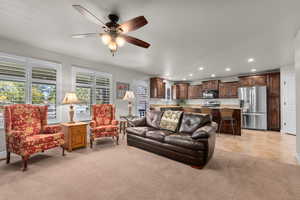 Tiled living room featuring ceiling fan