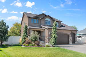 View of front of home featuring a garage and a front lawn