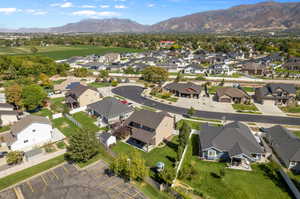 Birds eye view of property and nearby paved biking and walking trails with a mountain view