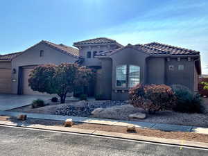 Mediterranean / Spanish home featuring a 3 car garage