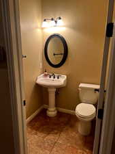 1/2 Bathroom with tile patterned flooring and toilet