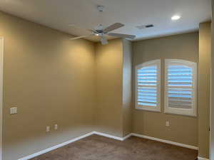 Unfurnished room with carpet and ceiling fan