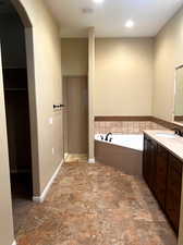 Bathroom featuring a bathing tub and vanity