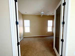 Den/Hobby room featuring french doors, carpet and ceiling fan