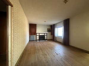 Unfurnished living room with light wood-type flooring and a textured ceiling