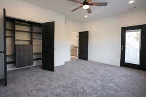 Unfurnished bedroom with carpet floors and ceiling fan