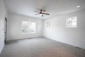 Unfurnished room with carpet floors and ceiling fan