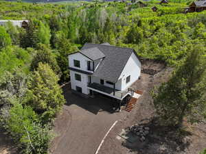 View from above of property featuring a heavily wooded area