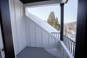 Snow covered back of property with a mountain view