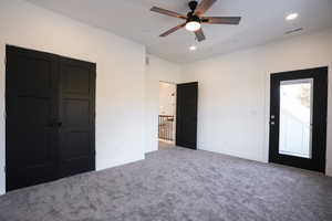 Unfurnished bedroom featuring ceiling fan and carpet flooring