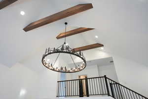 Room details with beam ceiling and a chandelier