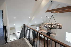 Staircase with lofted ceiling with beams