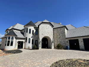 French provincial home with a garage