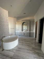 Bathroom featuring vanity and a tub