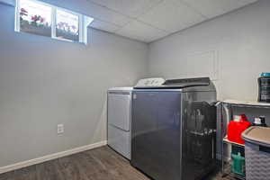 Laundry room featuring dark hardwood / wood-style floors and washer and dryer