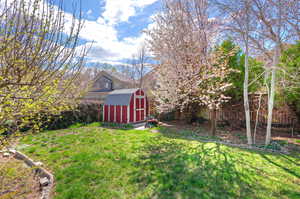 View of yard with a storage shed