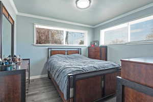 Bedroom featuring crown molding and hardwood / wood-style floors