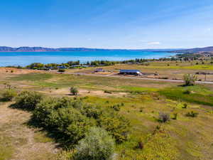 Drone / aerial view with a water and mountain view and a rural view