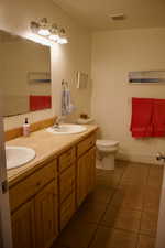 Bathroom featuring tile patterned floors, vanity, and toilet