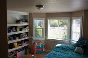 Bedroom featuring a textured ceiling and carpet floors