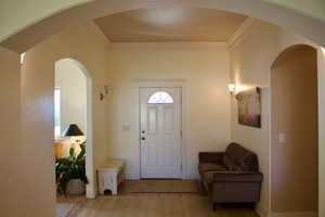 Entrance foyer featuring light hardwood / wood-style flooring and ornamental molding