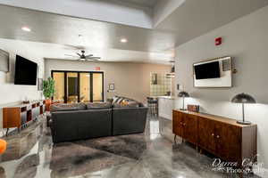 Living room with ceiling fan and a textured ceiling