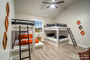 Bedroom with light hardwood / wood-style flooring and vaulted ceiling